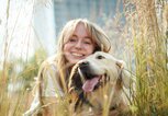 Person mit Hund im Gras | © Getty Images/LSOphoto