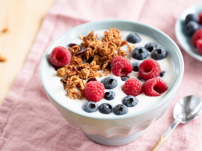 Quark mit Früchten und Müsli in Schüssel serviert | © Getty Images/Arx0nt