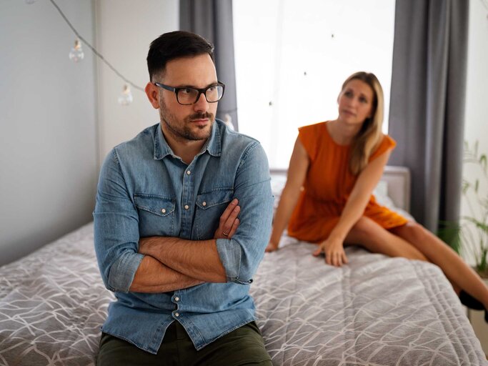 Paar sitzt nach einem Streit auf dem Bett | © Adobe Stock/NDABCREATIVITY