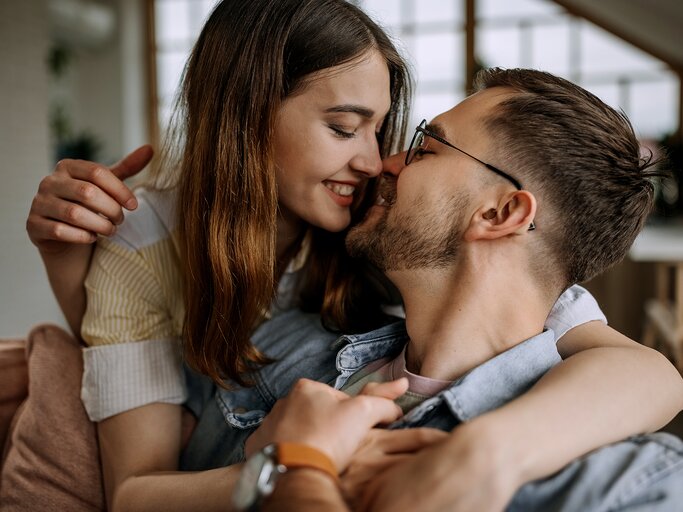 Eine Frau und ein Mann sind kurz davor sich zu küssen | © GettyImages/Pekic