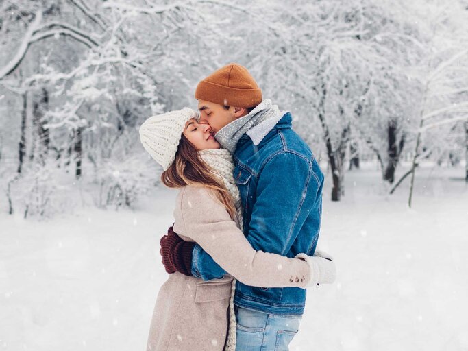 Verliebtes Paar küsst sich im Schnee. | © Getty Images / Maryviolet