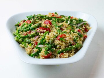 Quinoa-Salat mit grünem Spargel und frischen Kirschtomanten in einer weißen Schüssel. | © Getty Images / Selwa Baroody