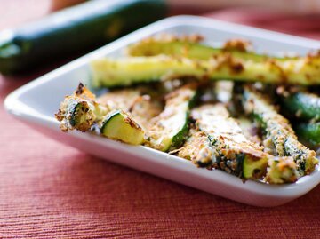 Gebackene Zucchini Pommes auf einem Teller | © Getty Images/JacobVanHouten