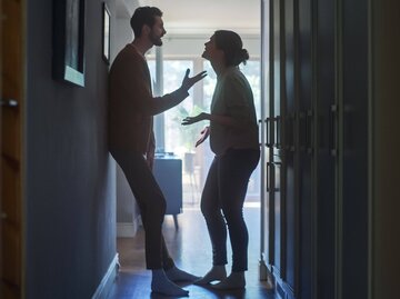 Mann und Frau streiten im Hausgang. | © Getty Images/gorodenkoff