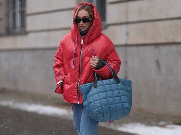 Sonia Lyson mit einer roten Pufferjacke und einer blauen Puffer Bag. | © Getty Images/Jeremy Moeller