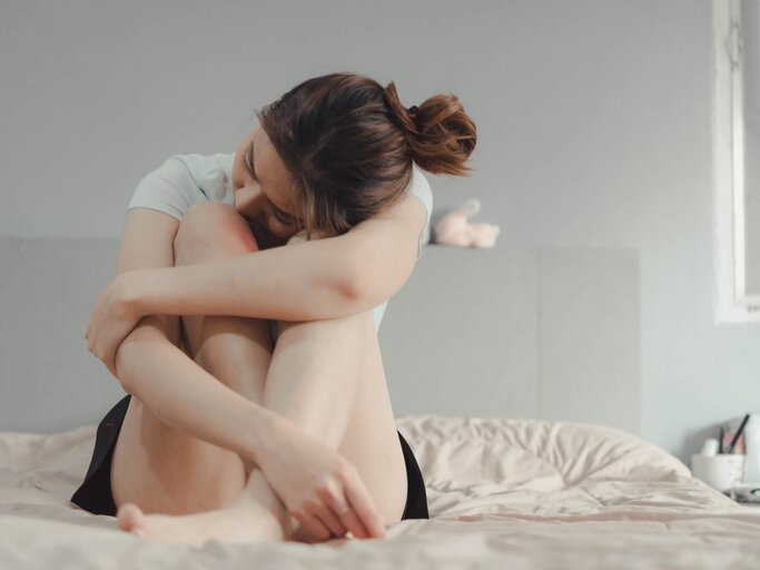 Frau sitzt auf dem Bett und ist traurig | © gettyimages.de| Atipati Netiniyom / EyeEm