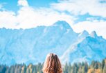 Frau im Sport-Outfit vor Bergpanorama | © iStock | AzmanL