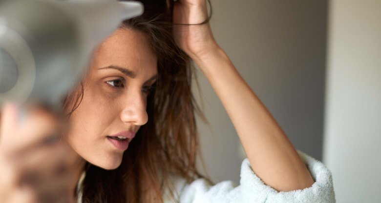 Haare föhnen - Frau föhnt sich die Haare | © iStock | EXTREME-PHOTOGRAPHER