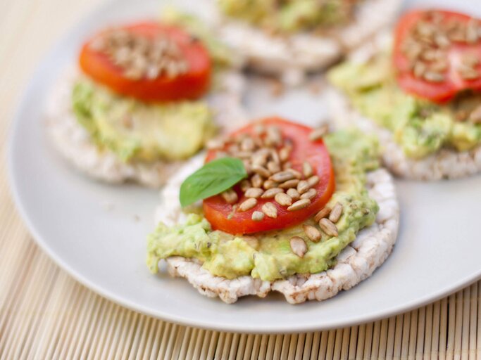 Reiswaffel mit Avocado, Tomate und Sonnenblumenkernen | © iStock | tjasam