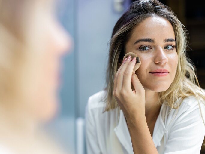 Frau trägt Make-Up auf | © iStock.com / skynesher