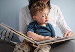 Eine Mutter liest mit ihrem Kind gemeinsam ein Buch. | © gettyimages.de / Catherine Delahaye