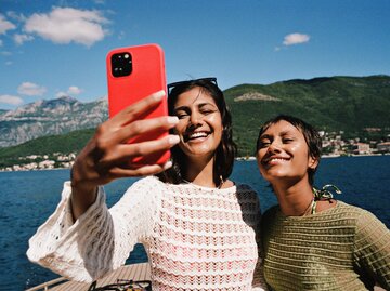 Zwei Freundinnen machen ein Selfie im Urlaub | © Getty Images/Klaus Vedfelt