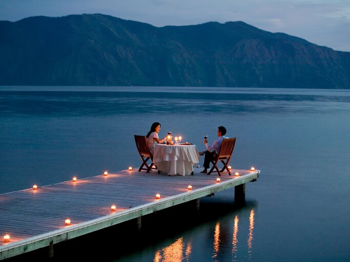 Paar am See beim Candlelight Dinner | © Getty Images/Ronnie Kaufman