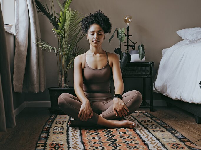 Entspannung und Meditation einer schwarzen Frau im Schlafzimmer. | © GettyImages/LaylaBird